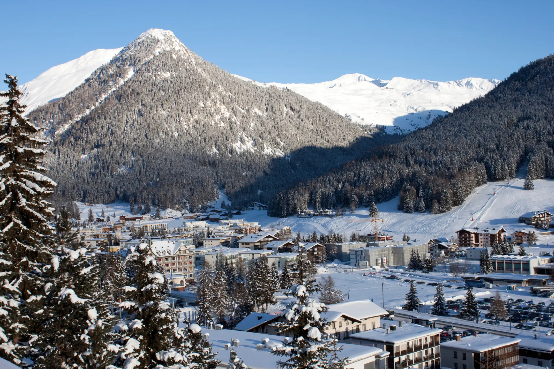 Davos Platz nestled beneath snow-covered alpine peaks on a clear winter day